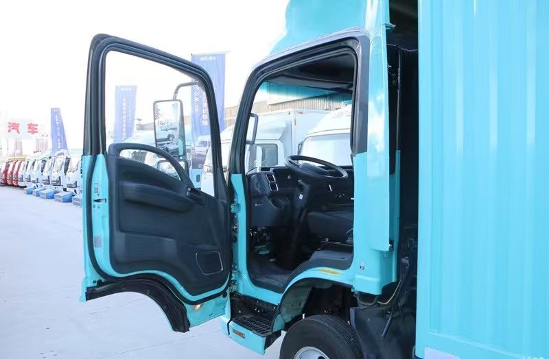 Open cab doors of the used Qingling EVM100 during warehouse inspection